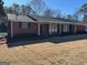 Charming brick ranch home with a covered front porch and manicured lawn at 2533 Whispering Pines Dr, Grayson, GA 30017