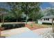 Well-maintained home featuring manicured landscaping, a brick walkway, and a detached garage at 2533 Whispering Pines Dr, Grayson, GA 30017