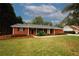 Charming brick home with a well-manicured lawn and inviting front porch at 2533 Whispering Pines Dr, Grayson, GA 30017