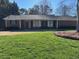 Charming brick home with manicured front lawn and classic ranch-style architecture at 2533 Whispering Pines Dr, Grayson, GA 30017