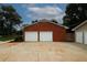 View of a brick two-car garage and separate one car garage at 2533 Whispering Pines Dr, Grayson, GA 30017