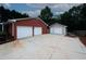Three garages with a driveway showing ample parking, set against a well-maintained lawn at 2533 Whispering Pines Dr, Grayson, GA 30017
