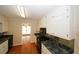 Traditional kitchen boasts white cabinets, black appliances, and dark green countertops at 2533 Whispering Pines Dr, Grayson, GA 30017