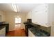 Traditional kitchen with white cabinets, dark countertops, and black appliances at 2533 Whispering Pines Dr, Grayson, GA 30017