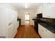 Spacious kitchen featuring white appliances and a view into adjacent room at 2533 Whispering Pines Dr, Grayson, GA 30017