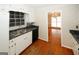 Kitchen features a stainless steel sink, window and view into an adjacent room at 2533 Whispering Pines Dr, Grayson, GA 30017