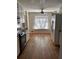 Well-lit kitchen with wooden floors, appliances, and view to the yard at 2533 Whispering Pines Dr, Grayson, GA 30017
