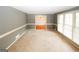 Large living room with carpet, large windows, and neutral-colored walls at 2533 Whispering Pines Dr, Grayson, GA 30017