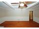 Spacious living room with hardwood floors, decorative beams, and a ceiling fan at 2533 Whispering Pines Dr, Grayson, GA 30017