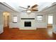 Bright living room with hardwood floors, ceiling fan, and brick fireplace at 2533 Whispering Pines Dr, Grayson, GA 30017