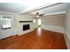 Hardwood floors, fireplace, and a ceiling fan adorn this living room at 2533 Whispering Pines Dr, Grayson, GA 30017