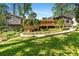 Backyard view of a beautiful home with a large deck, lush landscaping, and serene atmosphere at 3325 N Embry Cir, Atlanta, GA 30341