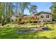 Spacious backyard with well-maintained lawn, fire pit, playground and deck on a charming home nestled among mature trees at 3325 N Embry Cir, Atlanta, GA 30341