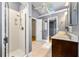 Bright bathroom featuring a double sink vanity, skylight, and tiled shower with glass door at 3325 N Embry Cir, Atlanta, GA 30341