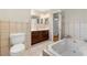 Bathroom featuring a bathtub, vanity with sink, toilet and tiled floor at 3325 N Embry Cir, Atlanta, GA 30341