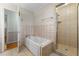 Bathroom featuring a bathtub, a shower with glass doors, and a tiled floor at 3325 N Embry Cir, Atlanta, GA 30341