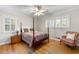 Cozy bedroom with hardwood floors, a four-poster bed, and natural light from windows at 3325 N Embry Cir, Atlanta, GA 30341