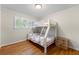 Charming bedroom featuring a bunk bed, hardwood floors, and plantation shutters at 3325 N Embry Cir, Atlanta, GA 30341