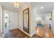 Inviting entryway with wood flooring and a view into the living room with a fireplace at 3325 N Embry Cir, Atlanta, GA 30341