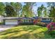 Charming single-story home featuring a lush front lawn, gray siding, and brick accents at 3325 N Embry Cir, Atlanta, GA 30341
