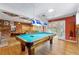 Spacious game room with a billiard table, hardwood floors, and brick accent wall at 3325 N Embry Cir, Atlanta, GA 30341