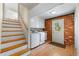 Bright laundry room with brick accent wall, new washer and dryer, and access to the backyard and upstairs at 3325 N Embry Cir, Atlanta, GA 30341