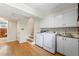 This laundry room features modern washer and dryer, built-in cabinets and sink, and convenient access to other parts of the home at 3325 N Embry Cir, Atlanta, GA 30341