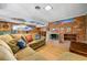 Cozy living room with a large sofa, brick fireplace, and hardwood floors at 3325 N Embry Cir, Atlanta, GA 30341