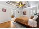 Relaxing main bedroom with a tray ceiling, ceiling fan, and ensuite bathroom at 3325 N Embry Cir, Atlanta, GA 30341