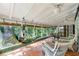 Relax in this sunroom with airy vaulted ceilings, ceiling fans, tile floor, and views of the lush backyard at 3325 N Embry Cir, Atlanta, GA 30341