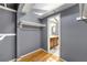 Spacious walk-in closet leading to the bathroom, featuring hardwood floors and custom shelving at 3325 N Embry Cir, Atlanta, GA 30341