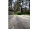View of the backyard featuring a weathered fence and overgrown shrubbery at 3604 Hopkins Ct, Powder Springs, GA 30127