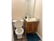 Cozy bathroom with toilet, vanity, sink, mirror, and blue bath mat at 3604 Hopkins Ct, Powder Springs, GA 30127