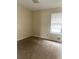Sunny bedroom with plush carpet and a window that lets in abundant natural light at 3604 Hopkins Ct, Powder Springs, GA 30127
