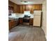 Well-lit kitchen with wood cabinets, stainless steel appliances, and modern flooring at 3604 Hopkins Ct, Powder Springs, GA 30127