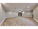 Expansive finished basement offering ample space, recessed lighting, and durable laminate floors at 609 Millstone Dr, Jonesboro, GA 30238