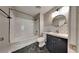 Bathroom with white subway tile, a black vanity, and marbling on the floor at 609 Millstone Dr, Jonesboro, GA 30238