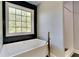 Relaxing bathroom featuring a soaking tub, white tile accents, and a large window with a view at 609 Millstone Dr, Jonesboro, GA 30238