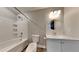 Bathroom featuring white vanity, subway tiles, and a white shower and tub at 609 Millstone Dr, Jonesboro, GA 30238