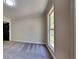 Bedroom with neutral walls, carpet, and a single window with white trim at 609 Millstone Dr, Jonesboro, GA 30238