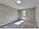 Bright bedroom featuring neutral carpet and walls, and a single window at 609 Millstone Dr, Jonesboro, GA 30238