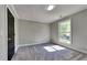 Comfortable bedroom featuring neutral paint, plush carpeting, a large window, and ample natural light at 609 Millstone Dr, Jonesboro, GA 30238