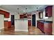 Well-equipped kitchen featuring cherry cabinets, granite countertops, a stylish backsplash, and stainless steel appliances at 609 Millstone Dr, Jonesboro, GA 30238