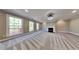 Spacious living room with a cozy fireplace, plush carpeting, and large windows for natural light at 609 Millstone Dr, Jonesboro, GA 30238