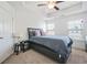 Bedroom with carpet, tray ceiling, a ceiling fan, and natural light at 6415 Shalks Crossing Dr, Lithonia, GA 30058