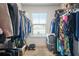 Walk-in closet with window offering natural light and ample storage space at 6415 Shalks Crossing Dr, Lithonia, GA 30058