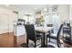 Well-lit dining area featuring hardwood floors, seamlessly connected to the modern kitchen at 6415 Shalks Crossing Dr, Lithonia, GA 30058