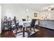 Open-concept dining area with hardwood floors, adjacent to a comfortable living space for seamless entertaining at 6415 Shalks Crossing Dr, Lithonia, GA 30058