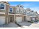 Charming townhome with stone accents, attached garage, and inviting entrance at 6415 Shalks Crossing Dr, Lithonia, GA 30058