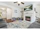 Bright living room featuring fireplace, ceiling fan, and open floor plan at 6415 Shalks Crossing Dr, Lithonia, GA 30058